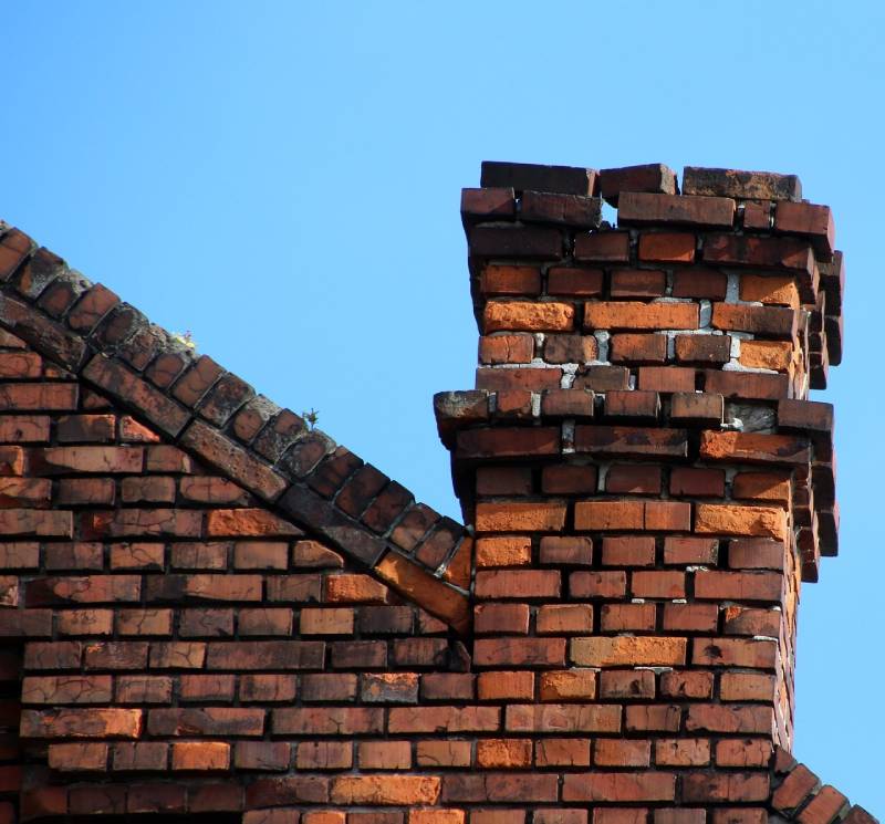 Signs Your Benbrook Home Needs a Chimney Inspection Damaged chimney on an Benbrook home showing cracks and missing mortar